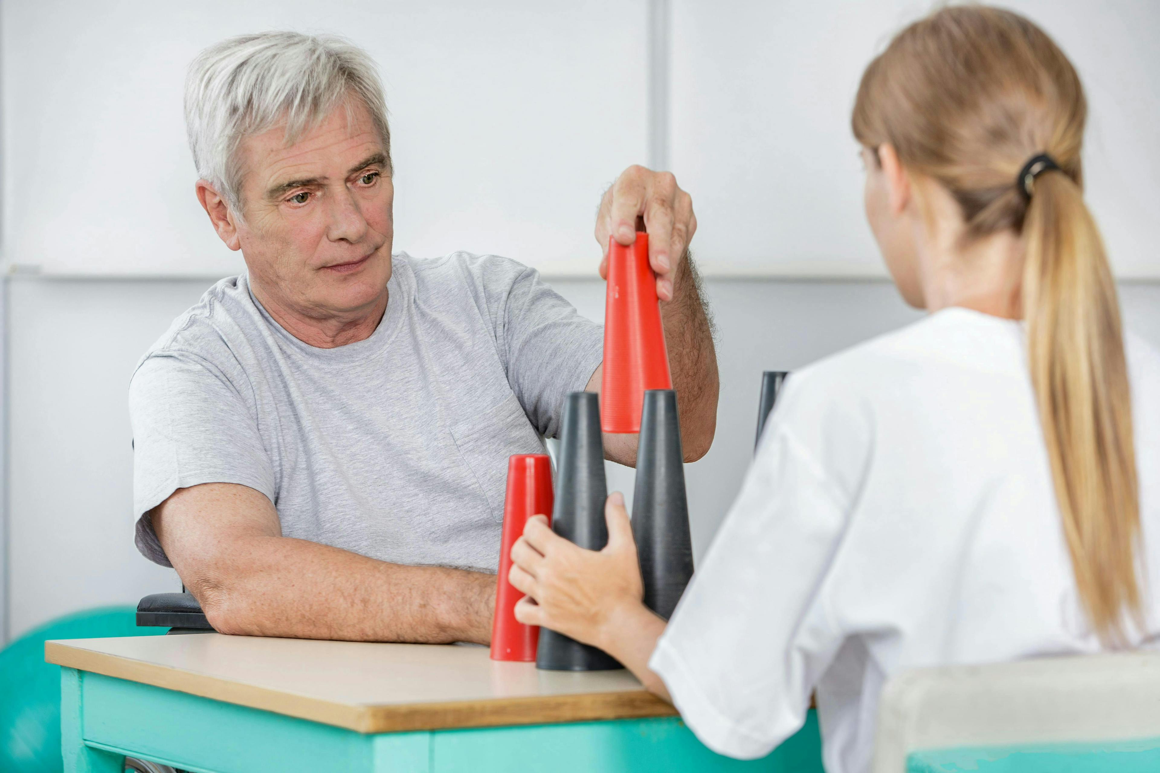 Senior playing with blocks and cones after brain injury